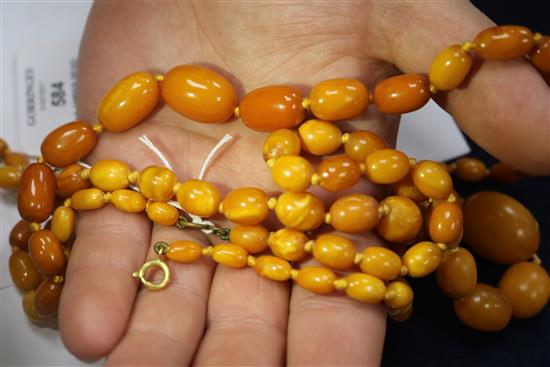 Two single strand graduated amber bead necklaces, gross weight 57grams.